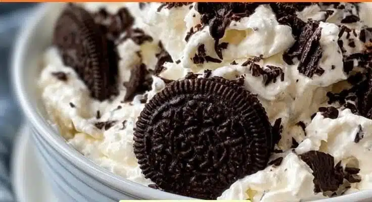 High Protein Oreo Fluff dessert in a bowl topped with crushed Oreos