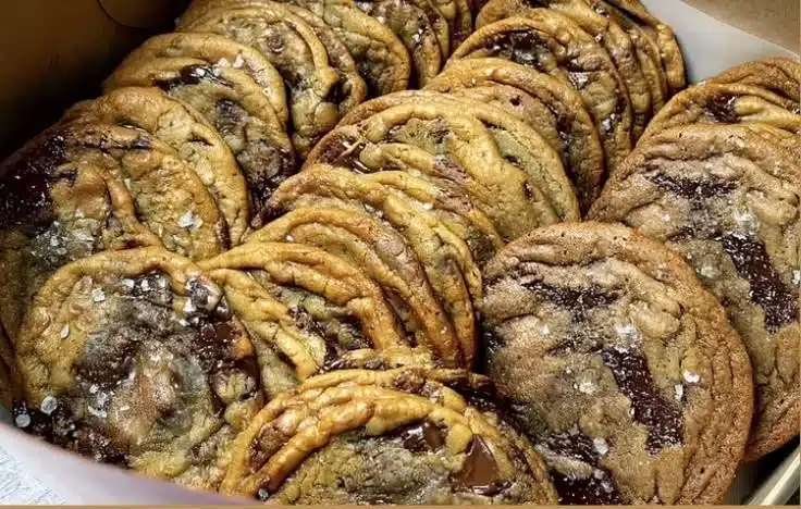 Freshly baked bakery-style chocolate chip cookies on a cooling rack