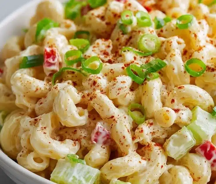 Delicious creamy Amish Macaroni Salad served in a bowl with fresh ingredients