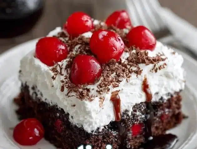 Delicious Black Forest Poke Cake topped with cherries and whipped cream