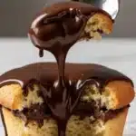 Chocolate fudge dessert cups topped with whipped cream and chocolate shavings