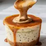 Delicious mini cheesecake cups topped with caramel sauce.