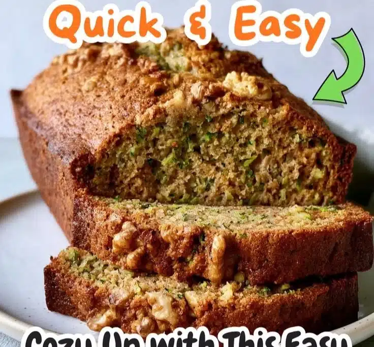 Moist zucchini bread with walnuts on a wooden cutting board