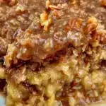 Delicious German chocolate cake with rich frosting and chocolate shavings.
