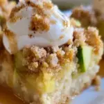 Zucchini pie bars topped with fresh herbs and sliced vegetables